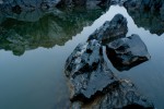 Rock formations and reflections in the calm waters of the Potomac River.