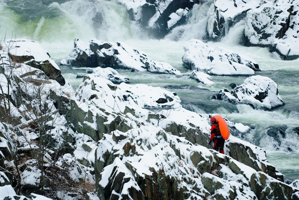 Climbing over snow covered rocks at Great Falls.