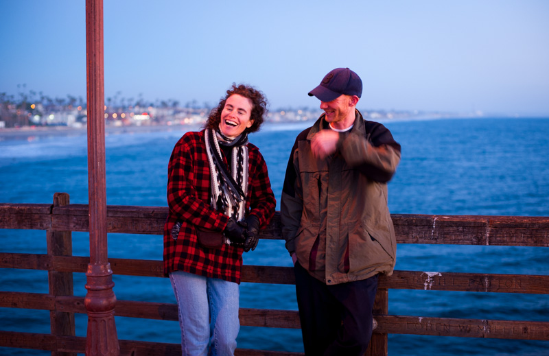 Woman and man laughing on the Oceanside pier in California.