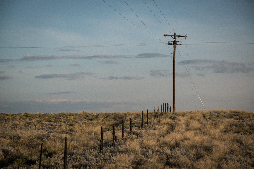 prairie scene. electrical lines and fence posts. monte vista, Colorado