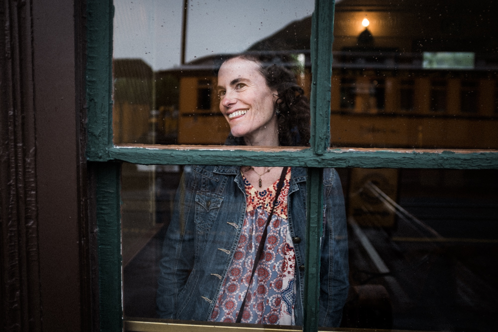 durango, colorado. woman in train station window on a rainy afternoon.