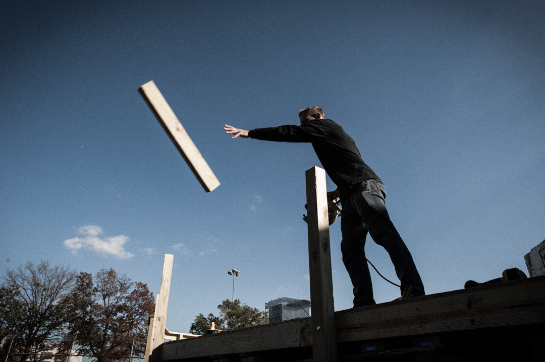 Dave Mutarelli tosses 4x4 piece of lumber off skate bowl deck.