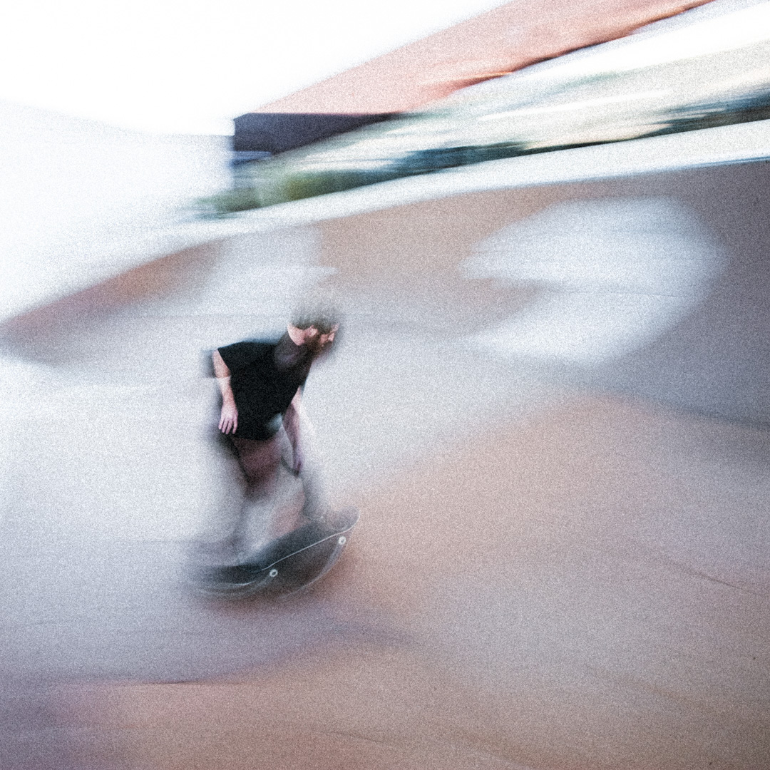 Skateboarder, Brewska, drops in the skate bowl. Motion blur with flash.