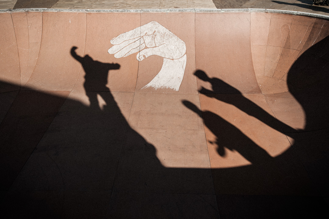 Shadows of skaters at the Finding A Line Bowl behind Union Market.