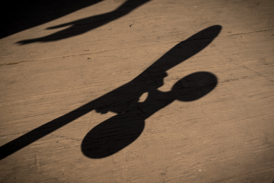 Skater waiting for his moment to drop in. View of shadows of skaters hand and board on deck.