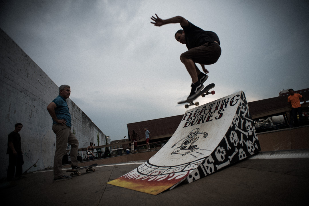 Ben Ashworth jumps over backside of ramp, lands on front side.