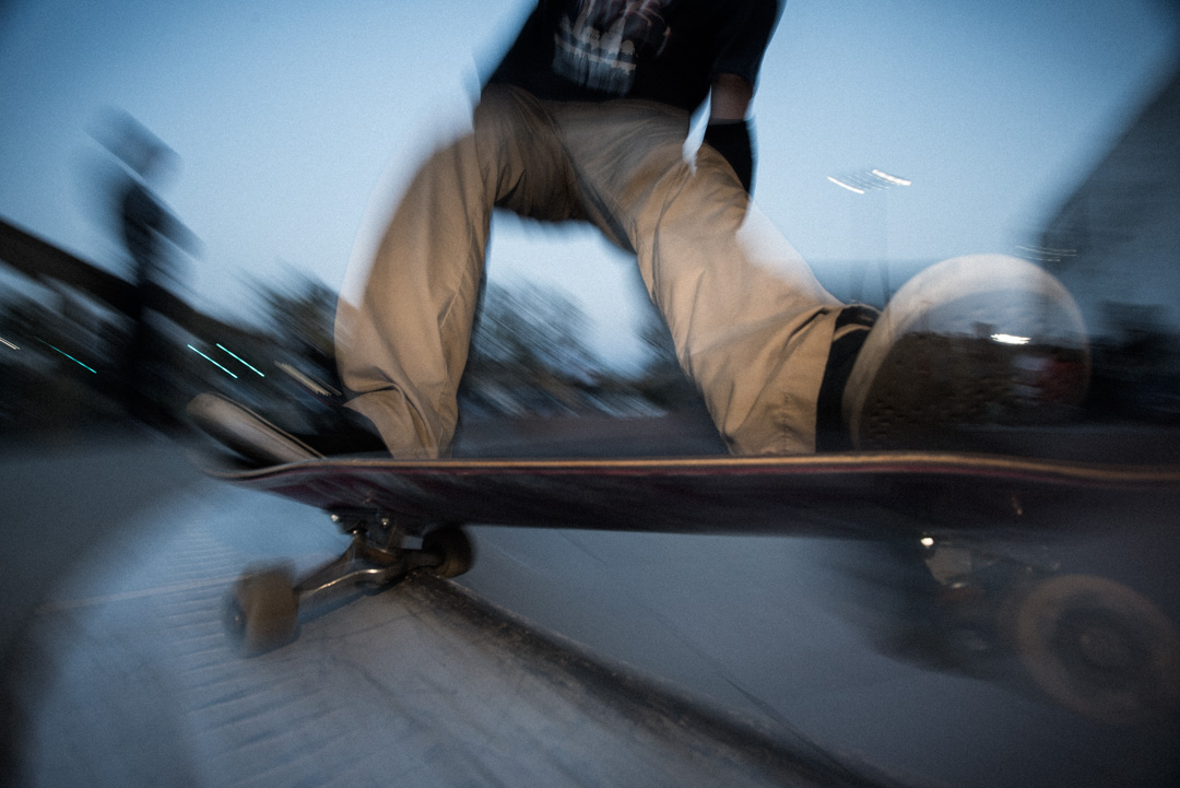 Close up of skater doing a 5-0 grind. Motion blur, flash.