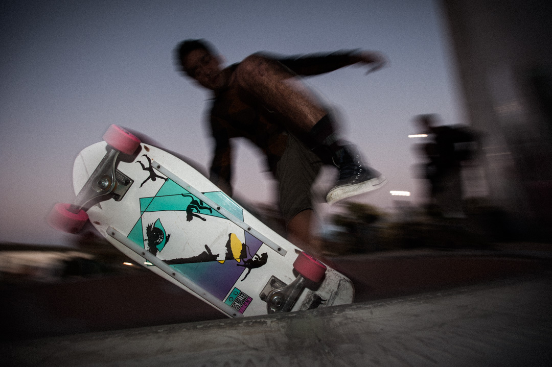 Close up of skater just before the bailout, silhouetted against the dusky sky. 