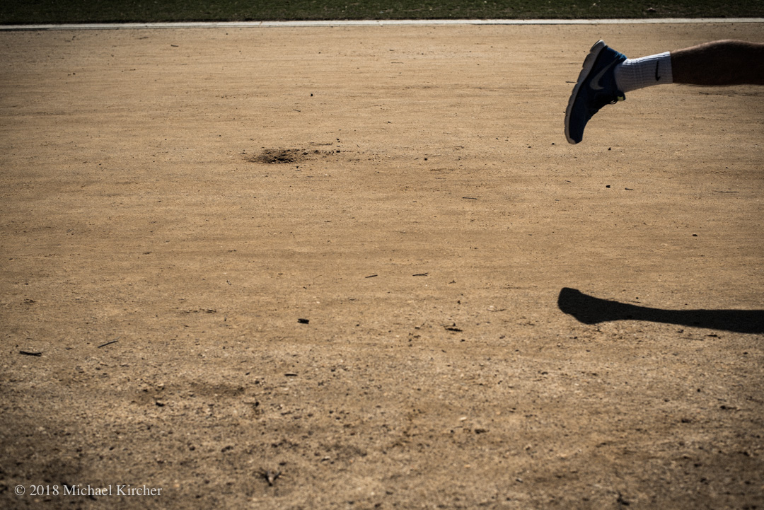 The leg and shadow of a jogger on the National Mall in Washington, DC. 